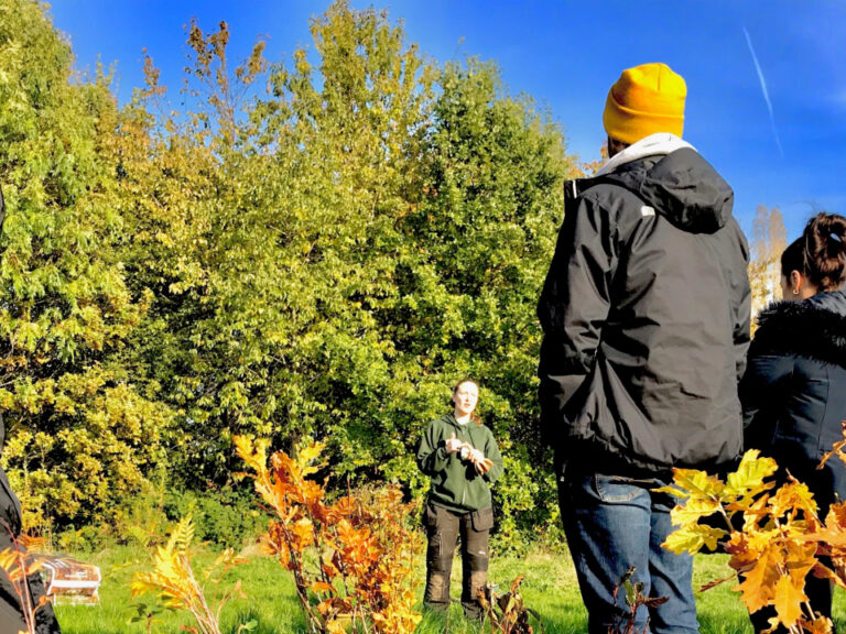 Individuals listening to tree planting demo