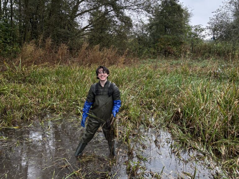 roots to work learner in waders in pond